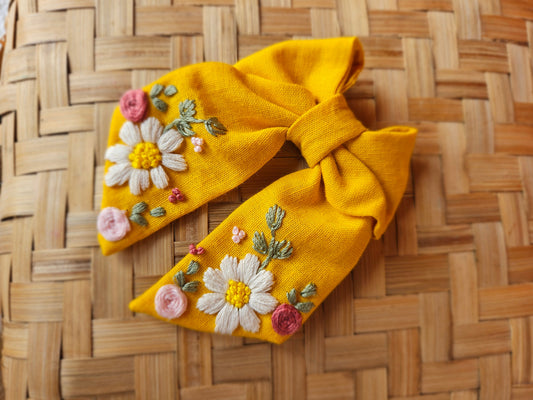 “Close up of hand embroidery on yellow floral sailor bow – Rui.cares”