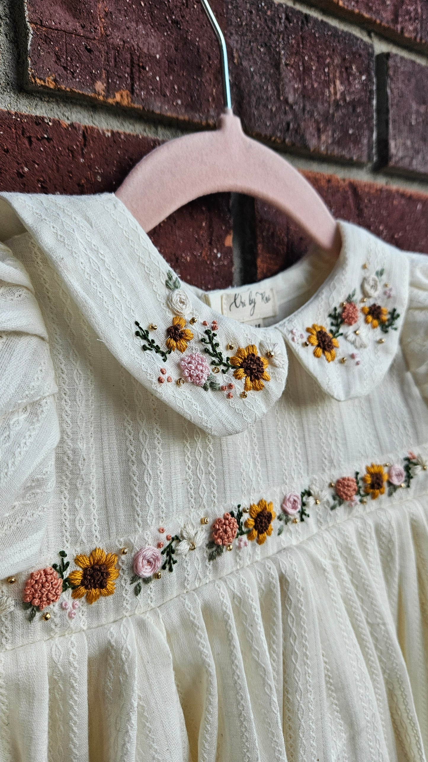 “Ivory baby dress with hand-embroidered sunflowers, roses, and puff sleeves – Rui.cares”