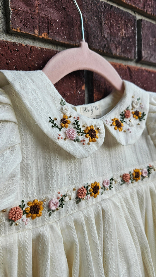 “Ivory baby dress with hand-embroidered sunflowers, roses, and puff sleeves – Rui.cares”