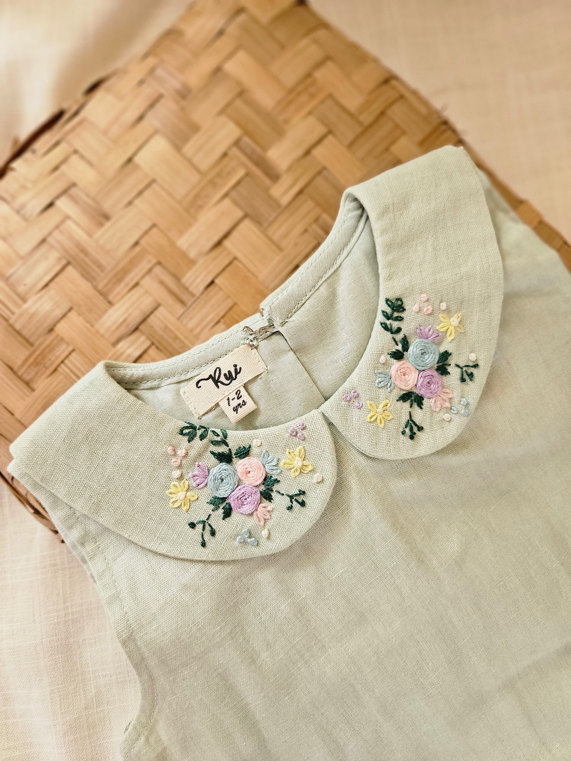 Handmade pastel green baby dress with embroidered collar