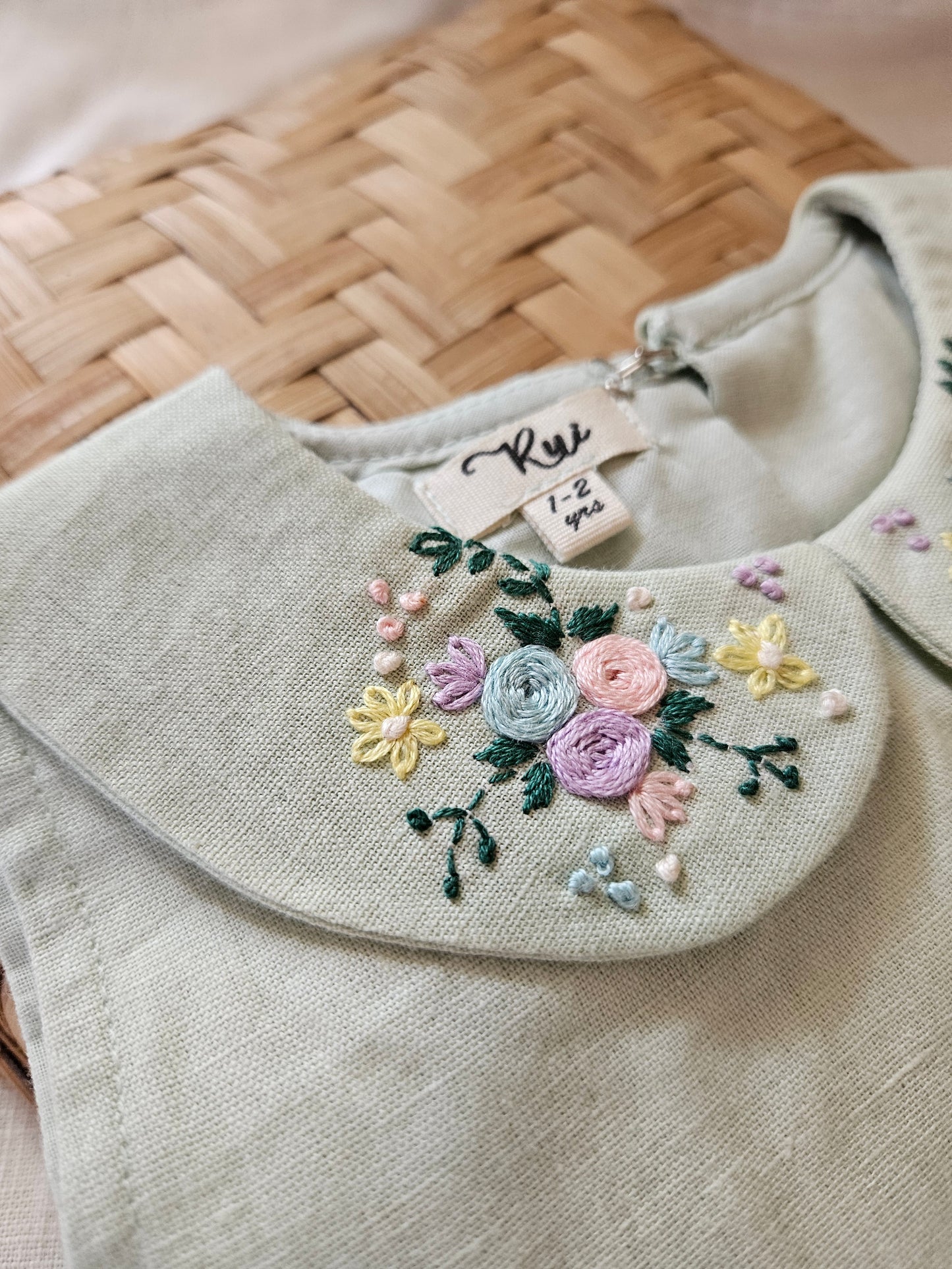 Minimal sage cotton linen toddler dress laid flat