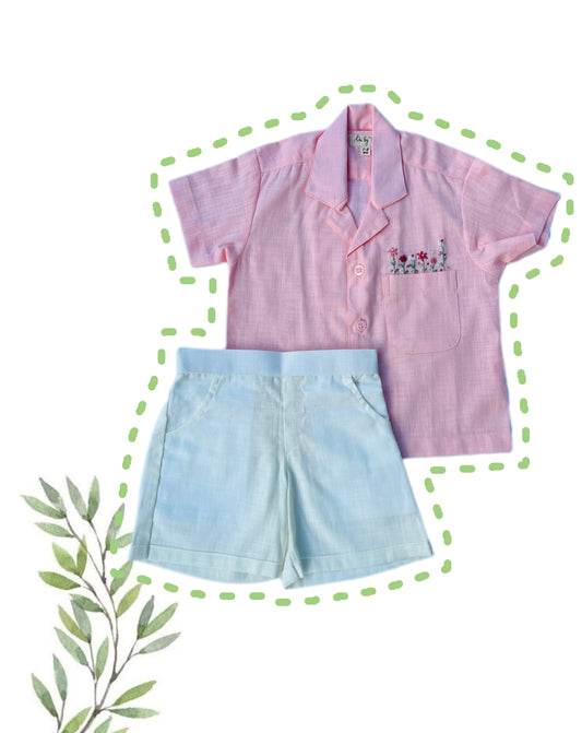 Flatlay of Bubble Gum pink shirt with pastelivory shorts.
